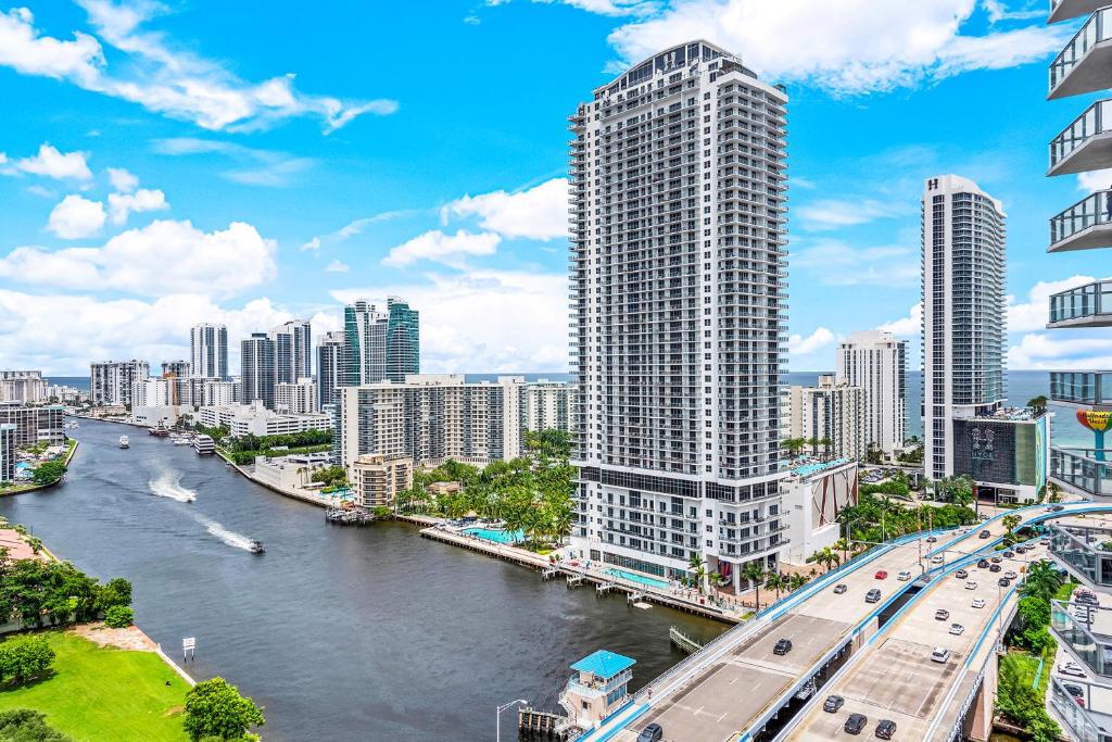 a view of a city with a river and buildings at Water View Building With Pool - 5-Min Walk To The Beach - Cozy Studios in Hallandale Beach