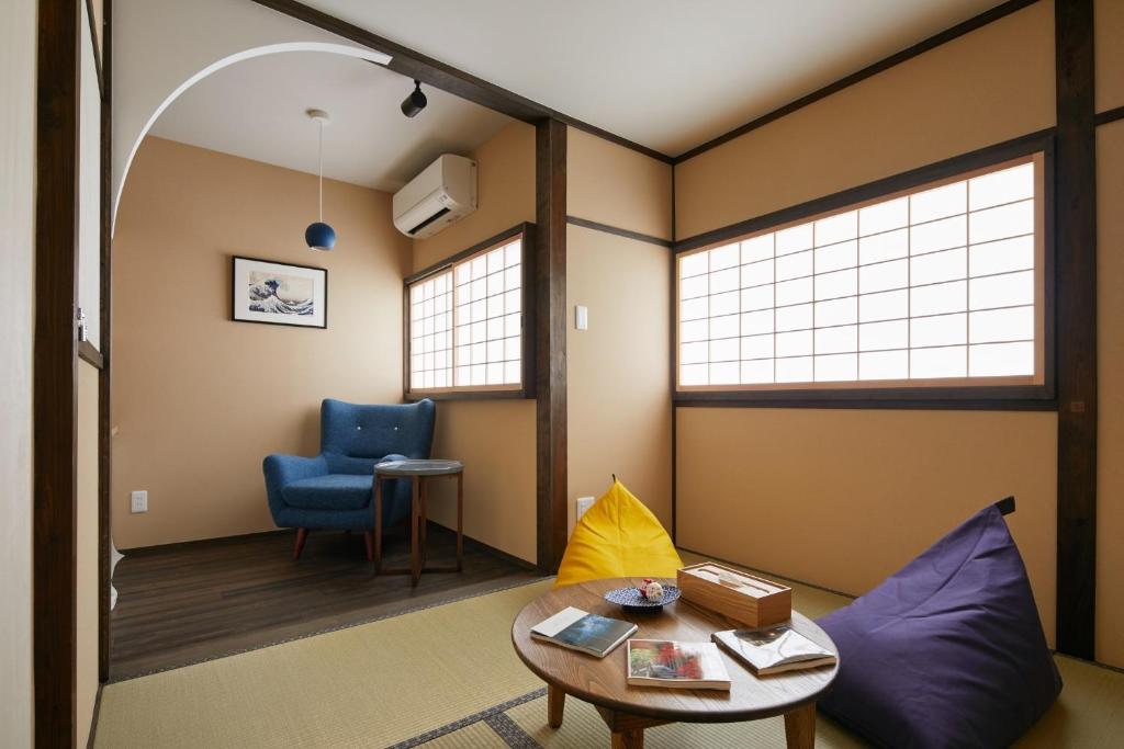 a living room with a couch and a table and a chair at Machizukitei - Vacation STAY 82078 in Kyoto