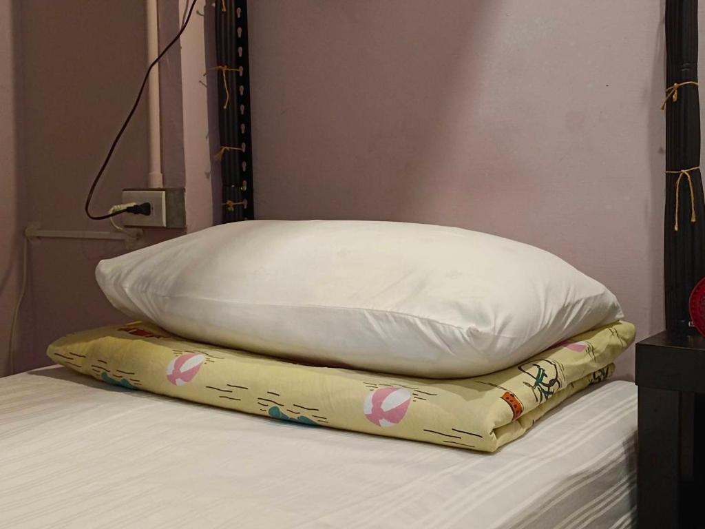 Postel nebo postele na pokoji v ubytování 東海小時光 Tong Hai Time Homestay