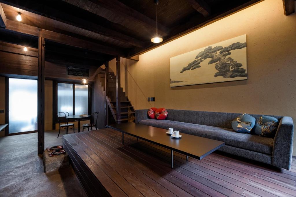 a living room with a couch and a coffee table at Rinn Premium Nijo Castle North in Kyoto