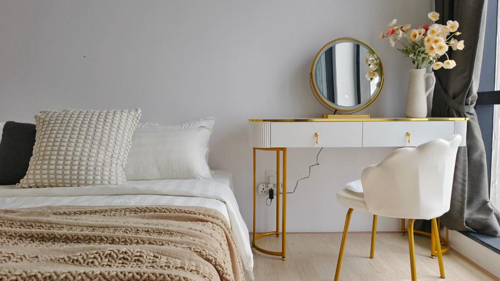 a bedroom with a bed with a mirror and a chair at A1. The Ins @ Aurpra Place beside Pavillion Bukit Jalil in Kuala Lumpur
