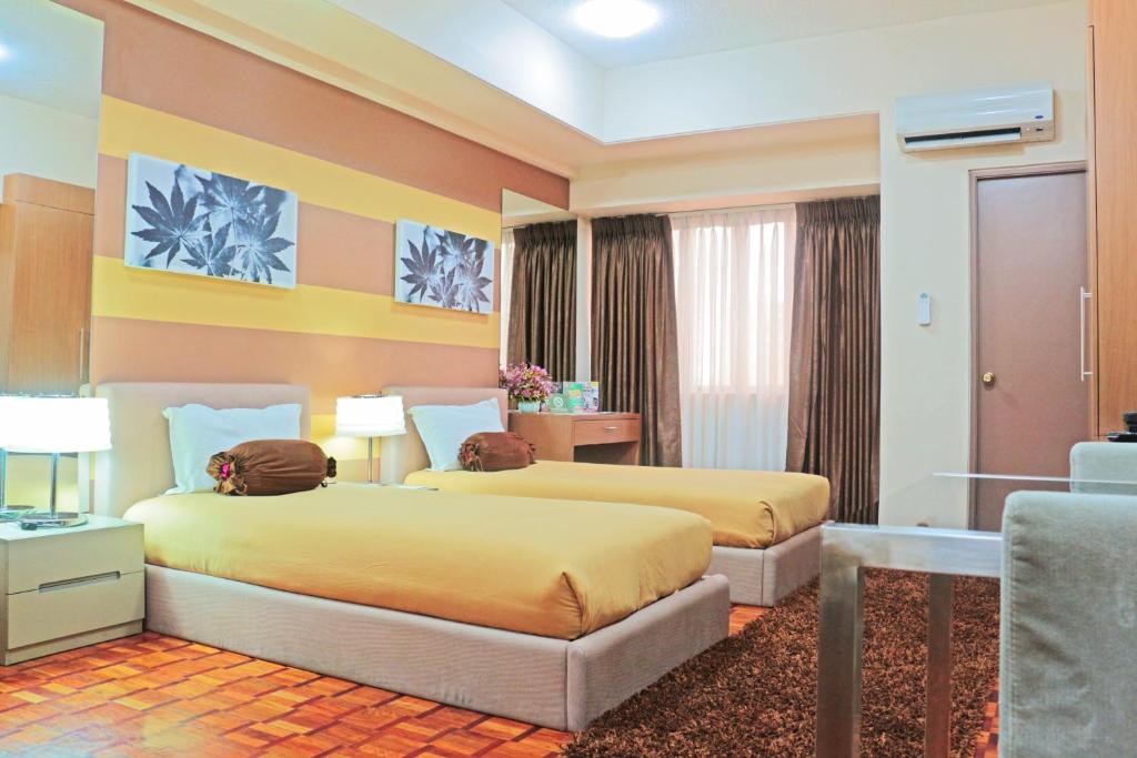 Postel nebo postele na pokoji v ubytování Prince Plaza II Condotel