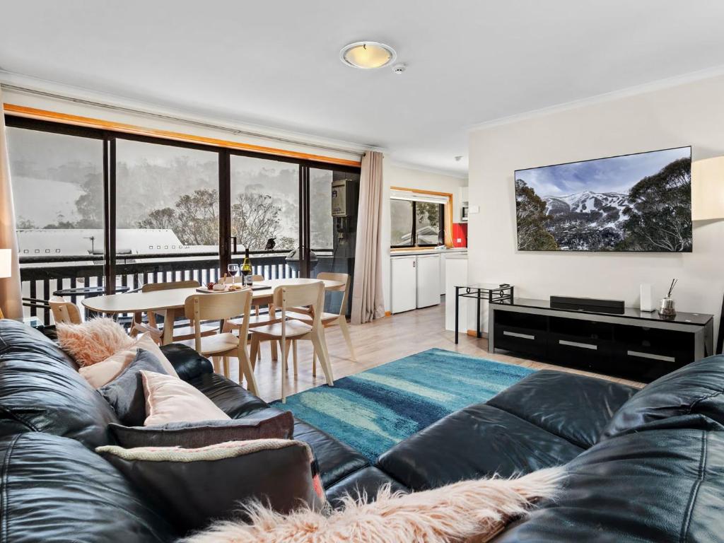 a living room with a couch and a table at Mowamba D1 in Thredbo