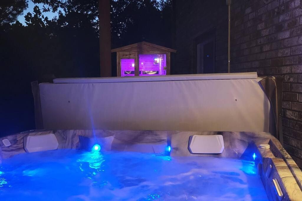 a hot tub with blue lights and a bird house at LI Airbnb - NWA mt bike, hike, and golf retreat in Bella Vista