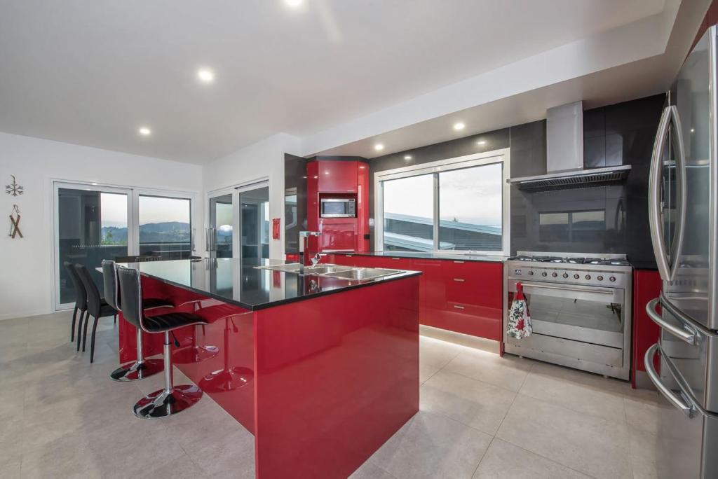 a kitchen with red cabinets and a red refrigerator at Stratton Summit 4 in Jindabyne