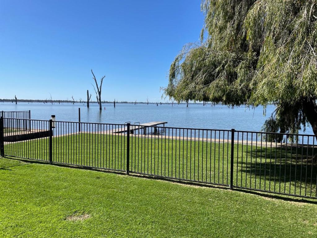 a fence in front of a body of water at Waterside Mulwala in Mulwala