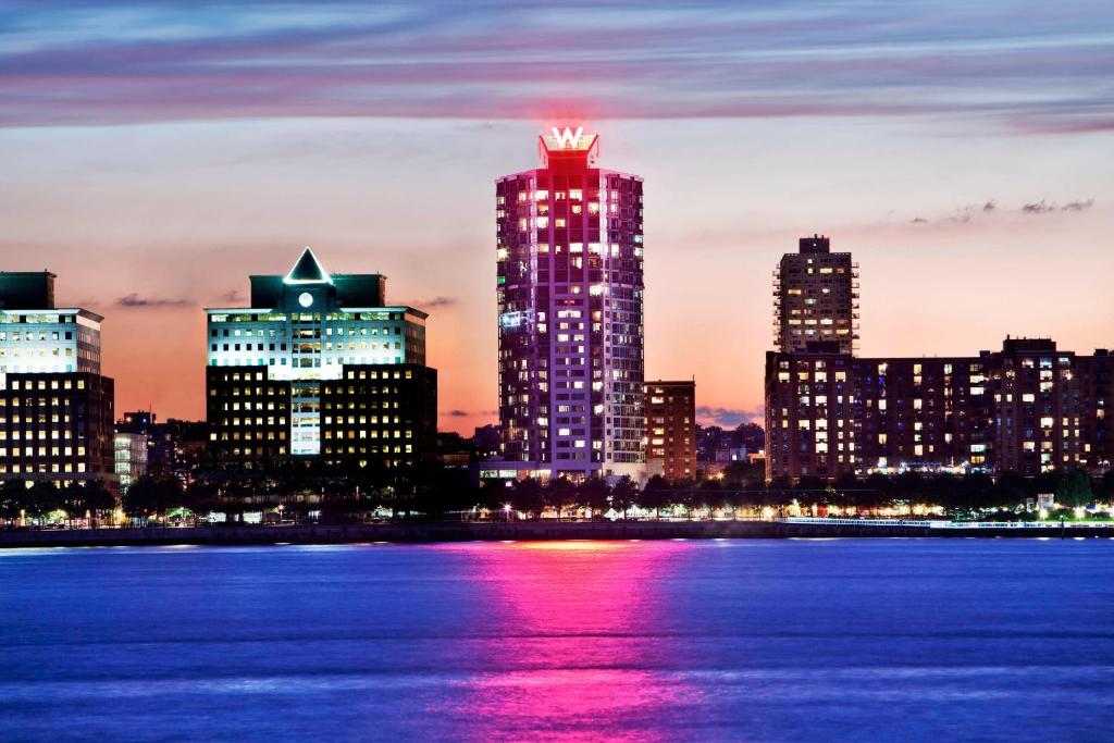 a view of a city skyline at night at W Hoboken in Hoboken