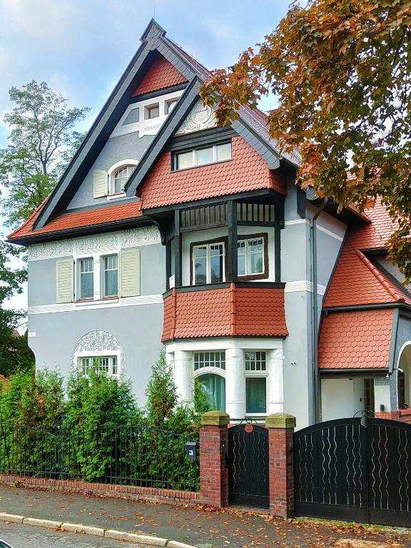 a large white house with a red roof at Villa Ley in Jelenia Góra