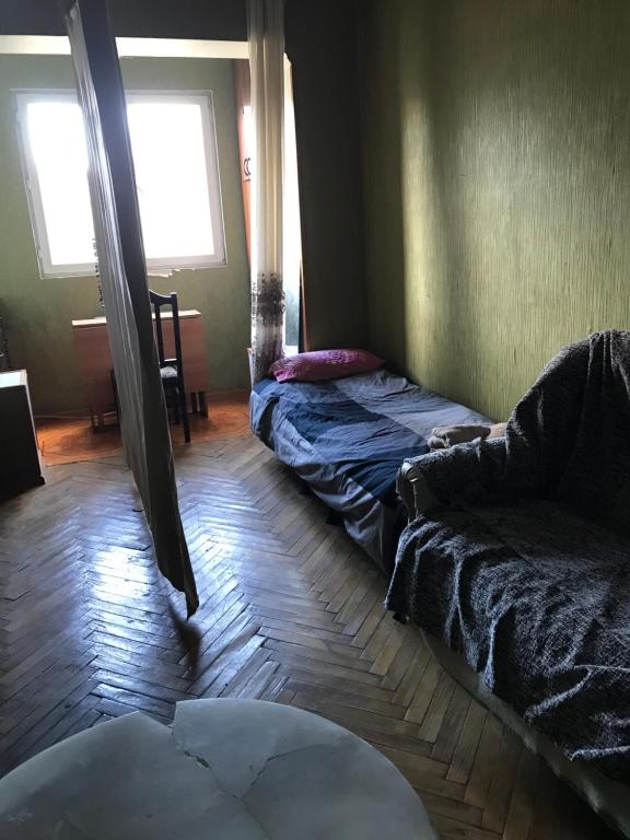 a living room with two beds and a couch at T7B hostel in Tbilisi City