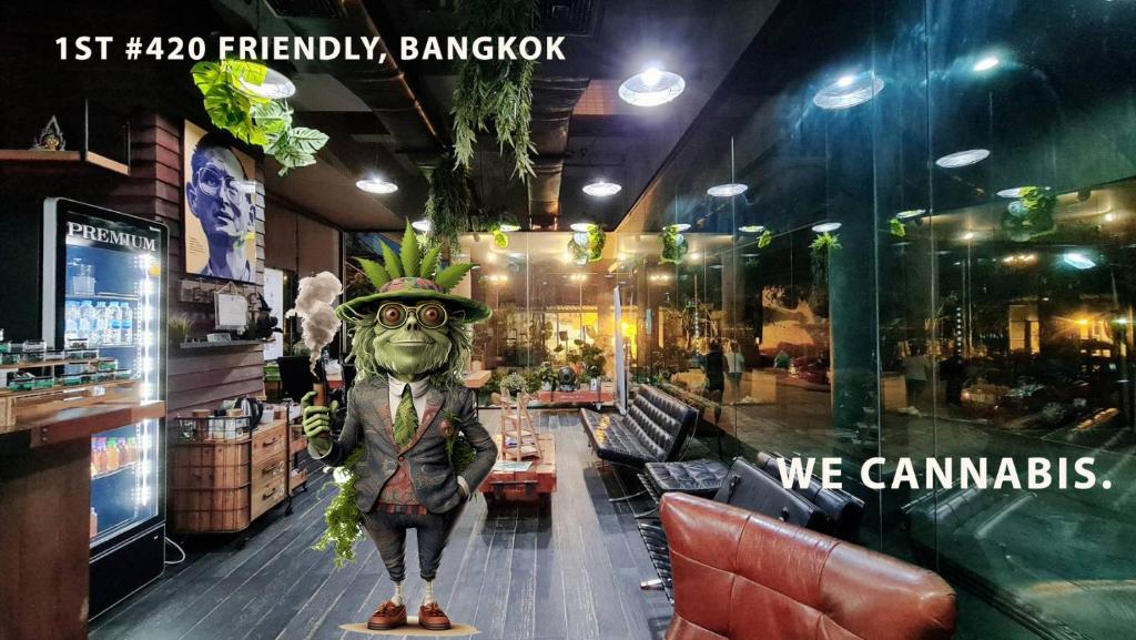 A themed lounge and dining area with booth seating, a drinks refrigerator, and a prominent character statue.