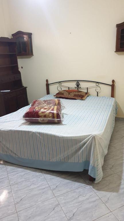 a bed with two pillows on it in a room at Hakim in Agadir