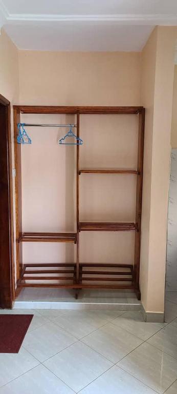 a room with a closet with shelves in it at Ronnie restate in Jinja