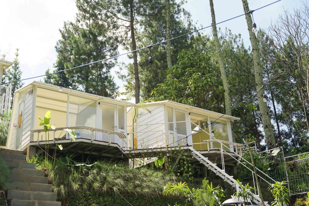 a tiny house on the side of a hill at Over Easy Glamping Site in Bandung