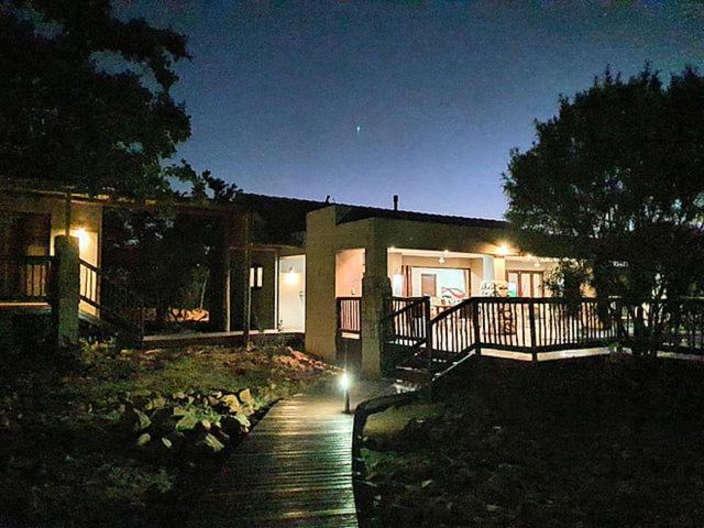 una casa por la noche con una pasarela delante de ella en Elements Golf Reserve House 303, en Moheme