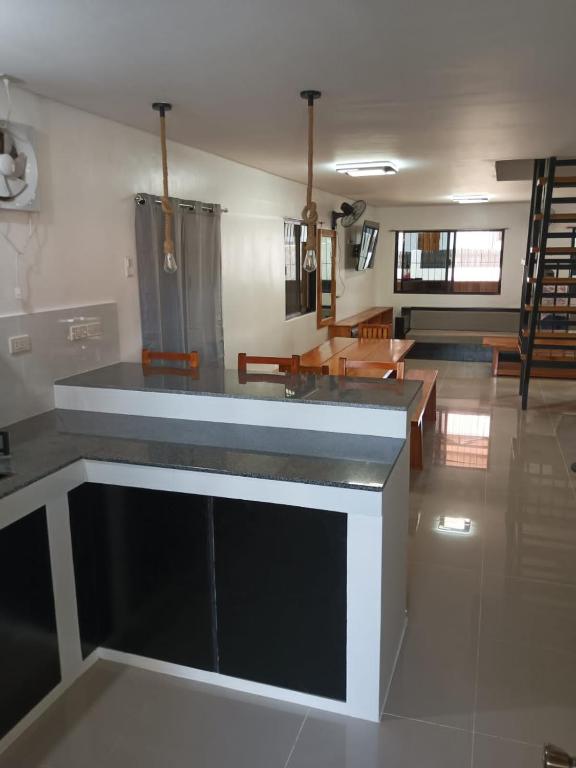 a kitchen with a counter top in a room at Angelito's Beach House 4 bedroom in General Luna