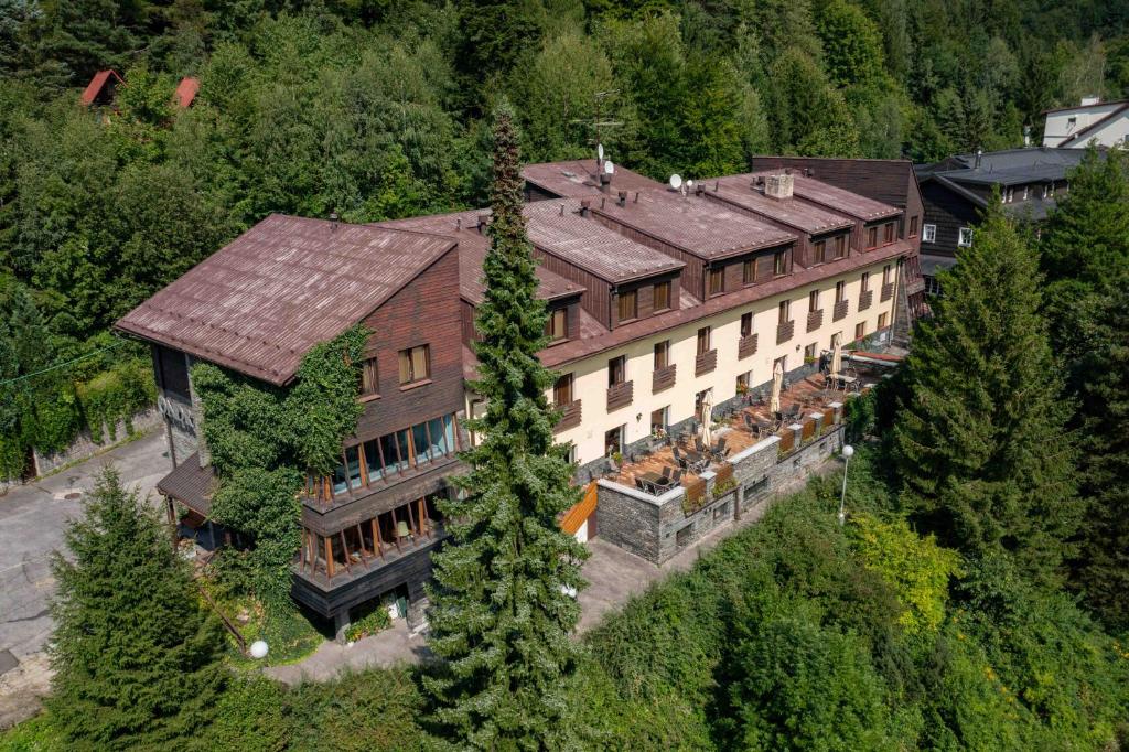 an aerial view of a large building in the forest at Hotel Ondras z Beskyd in Ostravice
