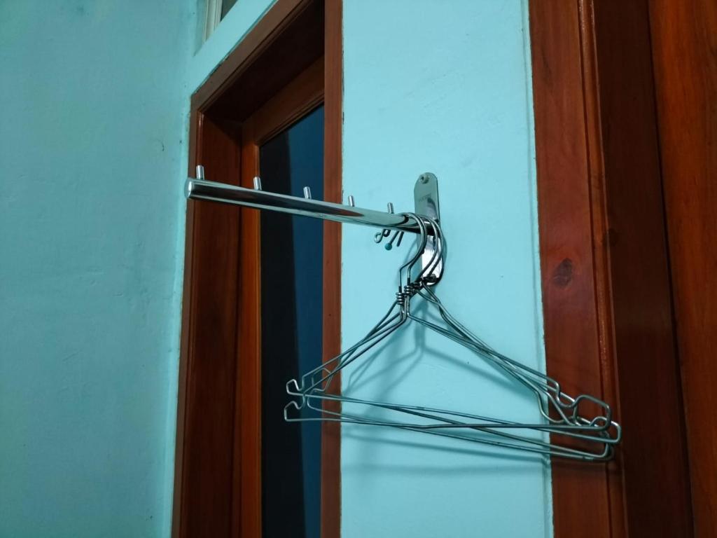 a metal door hanger in front of a door at Bito Homestay 
