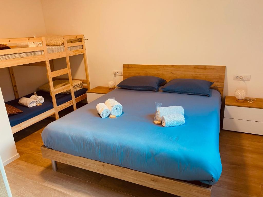 sypialnia z niebieskim łóżkiem i 2 łóżkami piętrowymi w obiekcie Wild Side w mieście Mollia