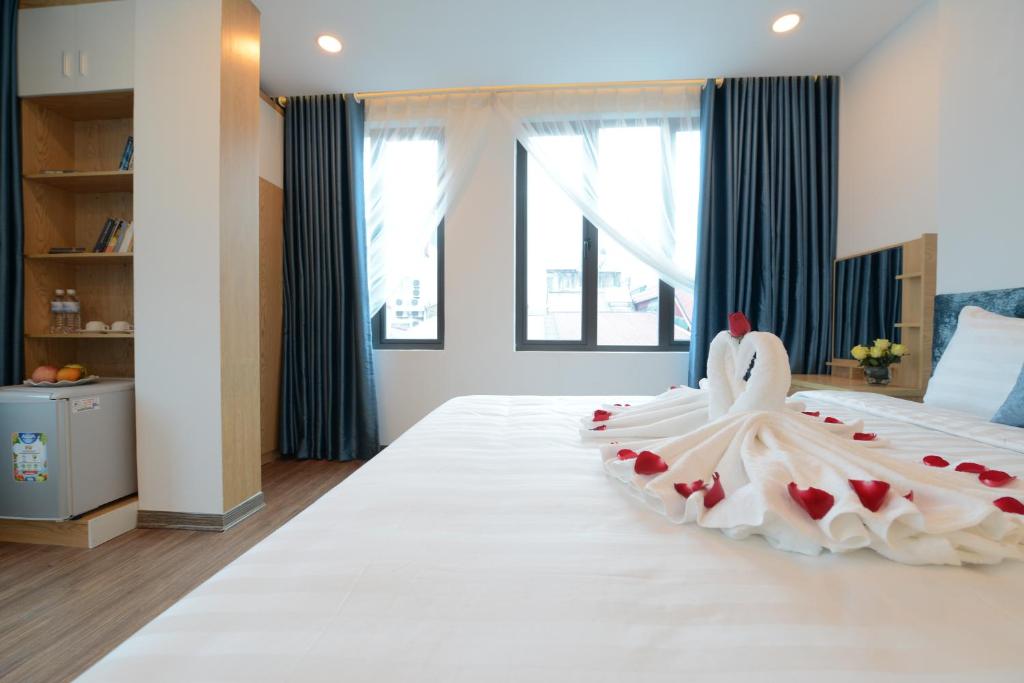 Postel nebo postele na pokoji v ubytování Hanoi Prime Garden Hotel & Spa