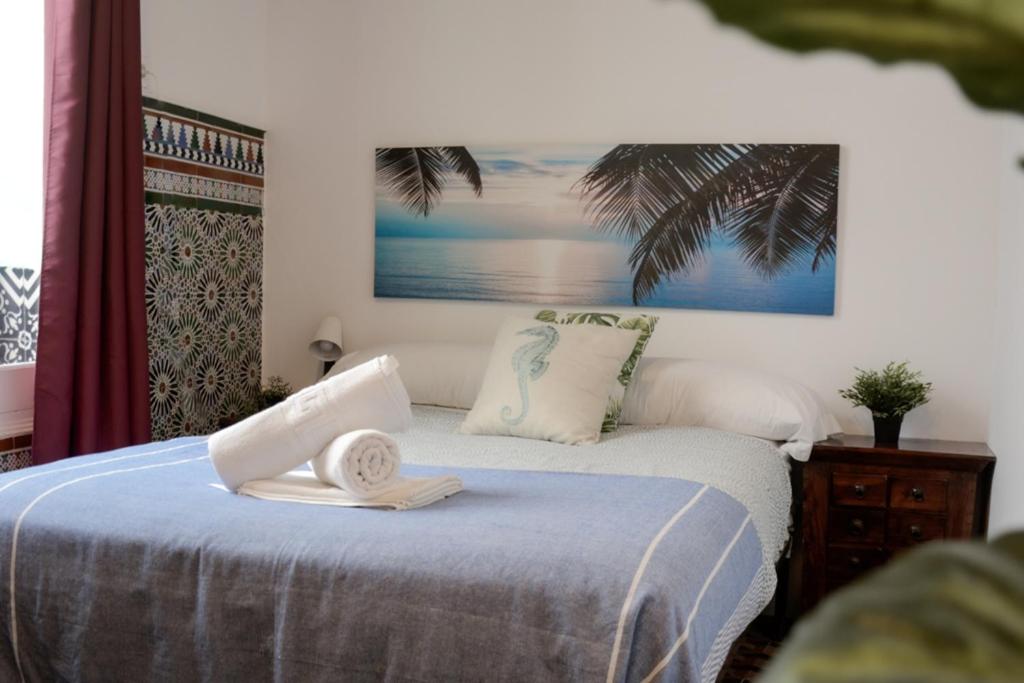 a bedroom with a bed with a towel on it at Lion Hostel By Rebels kiteschool in Tarifa