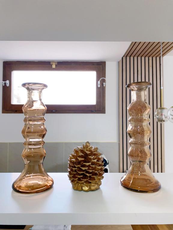 two glass vases sitting on a white table at Chez les deux garçons in Montrouge