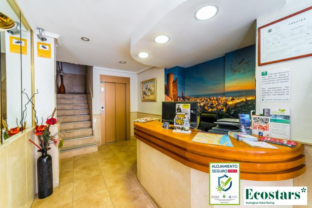 a bar in a restaurant with a counter at Hotel Sevilla in Almería