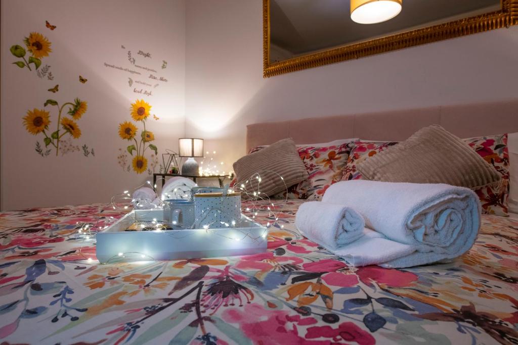 a bedroom with a bed with towels on it at Borgo Trento Home, incantevole appartamento in Verona