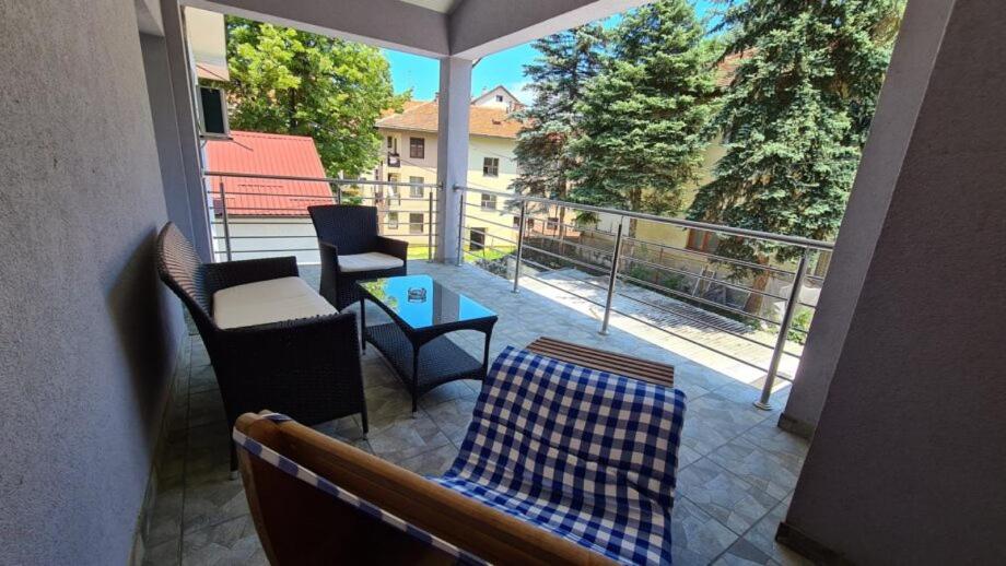 a balcony with chairs and a table and a view at Apartment Harmony in Višegrad