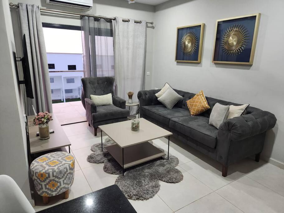 un soggiorno con un divano e un tavolo di Casa M- 1 bedroom apartment Aquaview complex a Bijilo