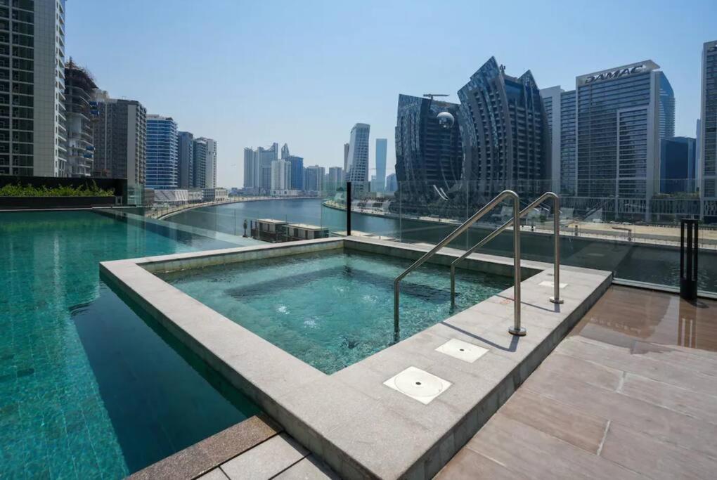 a swimming pool on the roof of a building at Meerak Homes - Glamorous 2 bed Apartment with Panoramic Views - Business Bay with free Wifi, Parking, Gym and Pool in Dubai