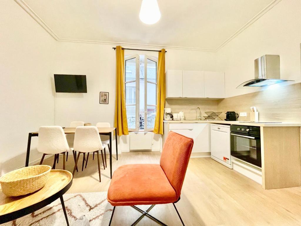 Saint Nazaire - 2 Appartements - Centre Ville في سان نازير: مطبخ وغرفة طعام مع طاولة وكراسي