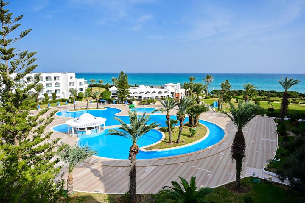 an aerial view of a resort with a pool and the ocean at Mahdia Palace Thalasso in Mahdia