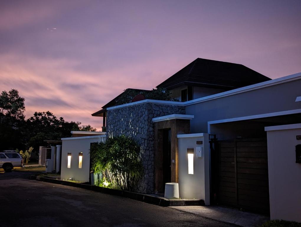 a house with lights on the side of it at night at Horizon Vista Pool Villa Family Retreat Bangtao in Phuket Town