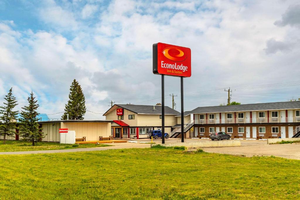 a sign for a gas station in front of a building at Econo Lodge Inn & Suites in Pincher Creek