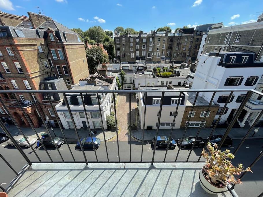 a balcony with a view of a city with buildings at Large South Facing Studio Flat in London