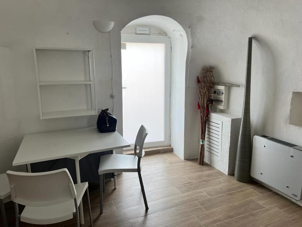 a kitchen with a table and chairs in a room at Trullo Sofia in Monopoli