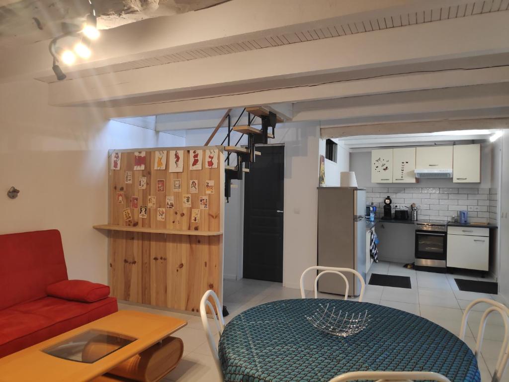 a living room with a red couch and a table at Maison 4 personnes in Caillac