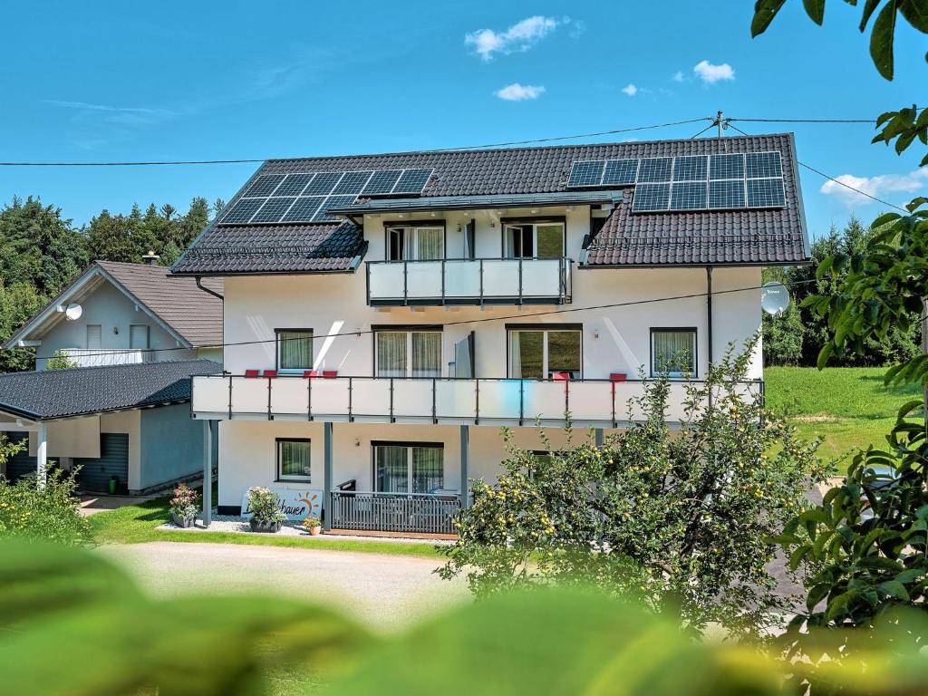 a house with solar panels on its roof at Apartment Elisabeth by Interhome in Egg am Faaker See