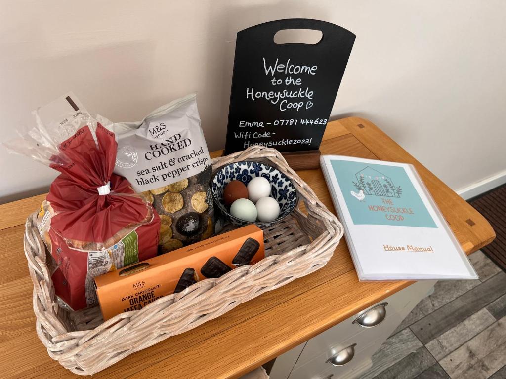 a basket of food and a sign on a table at The Honeysuckle Coop in Grantham