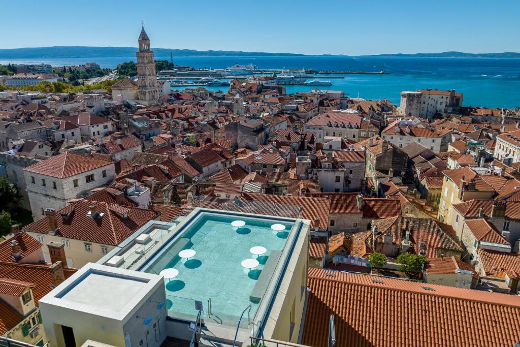 a view of a city with a swimming pool at Cornaro Hotel in Split