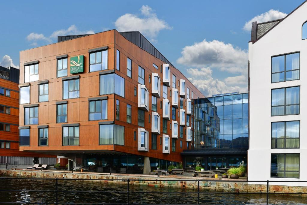 a building next to a body of water at Quality Hotel Waterfront in Ålesund