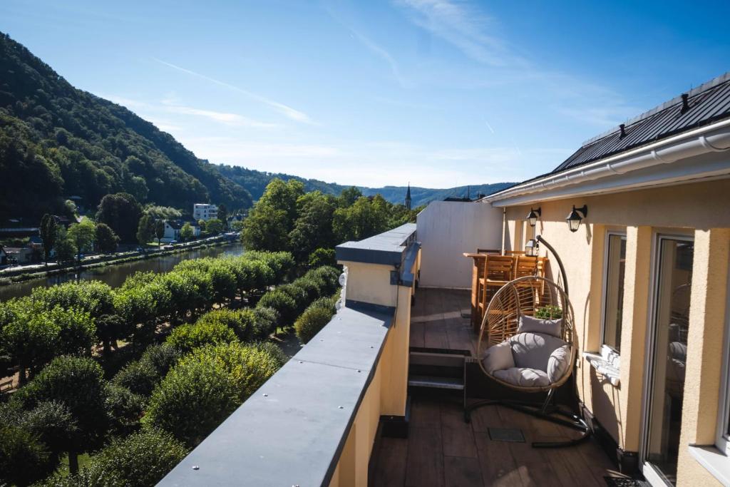 a balcony with a view of a river and trees at Apartment am Kurpark mit traumhafter Terrasse in Bad Ems