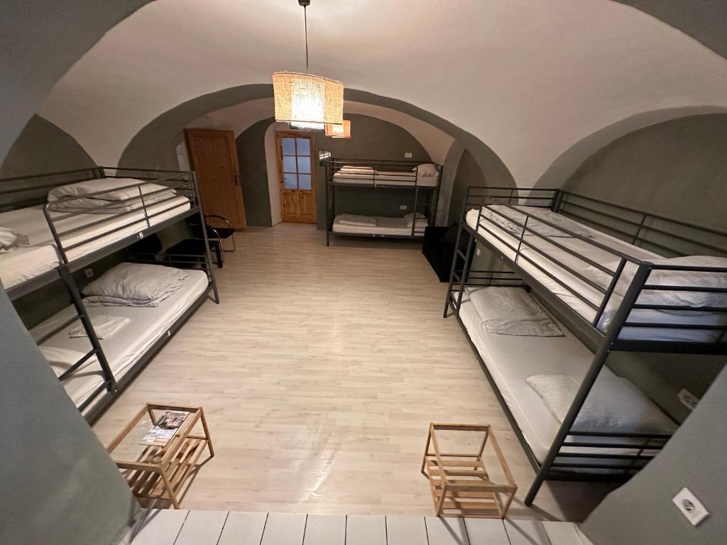 a room with three bunk beds and a hallway at Hostel Sleeping Beauty in Ljubljana