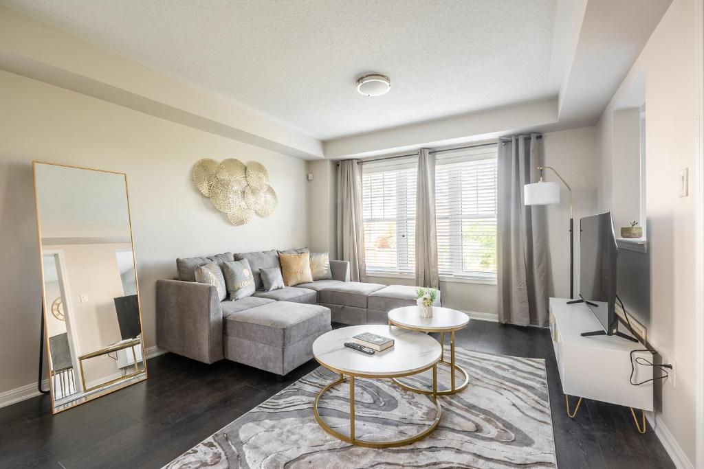 a living room with a couch and a table at GLOBALSTAY Modern 3 Bedroom House in Brampton in Brampton