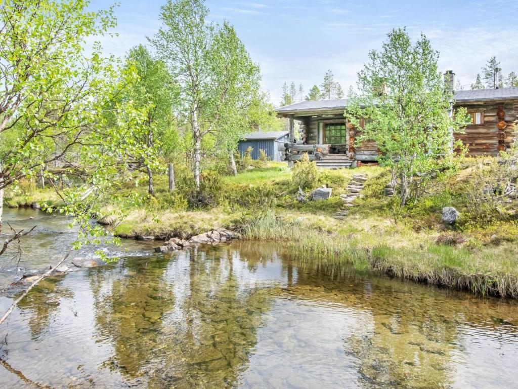 a log cabin with a river in front of it at Holiday Home Kelokoto by Interhome in Saariselka