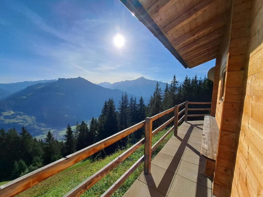 uma varanda de uma casa com vista para as montanhas em Chalet Nasenalmhütte by Interhome em Hippach