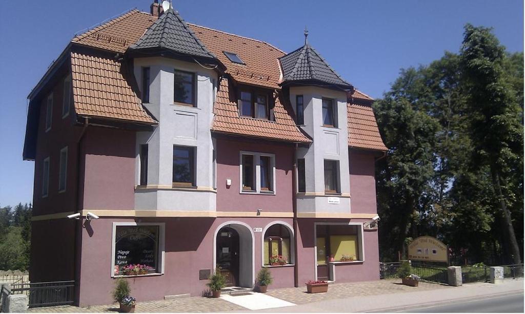 a large pink house with a tile roof at Willa Pod Wieżami in Karpacz