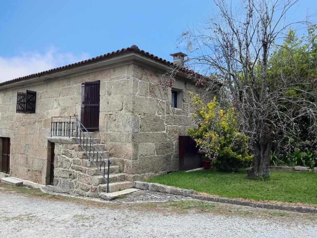 a stone building with a staircase in front of it at Casa do Tanque in Vila Nova de Famalicão