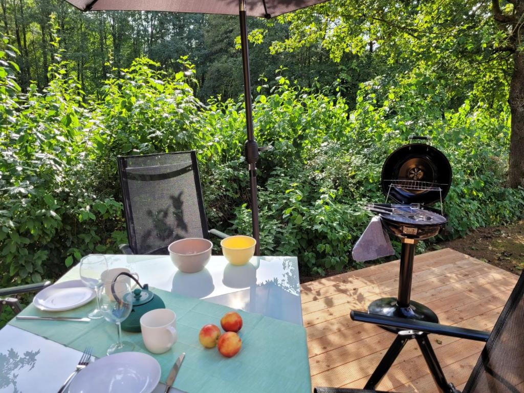 a table with an umbrella and a dog in the background at Holiday Home Soul & Lake by Interhome in Wemding