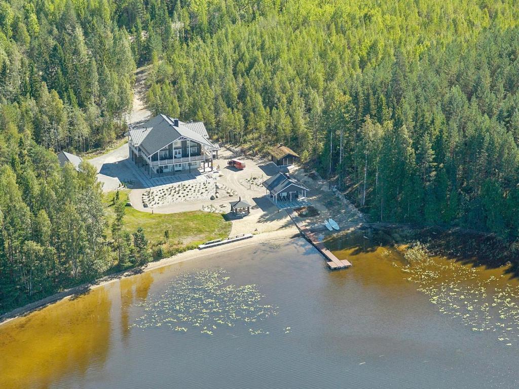 an aerial view of a large house on the water at Holiday Home Villa keidas by Interhome in Pertunmaa